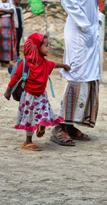 Rear view of girl standing outdoors