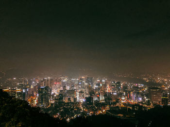 High angle view of illuminated buildings against sky at night in seoul, korea.