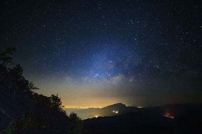 Scenic view of star field over landscape at night