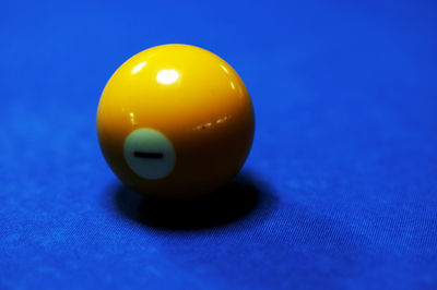 Close-up of yellow ball on pool table