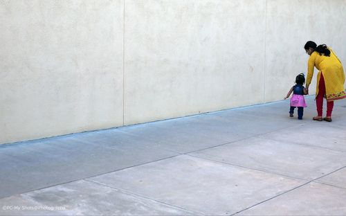 Full length of woman standing on bench