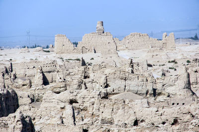 Low angle view of rocks on shore against sky