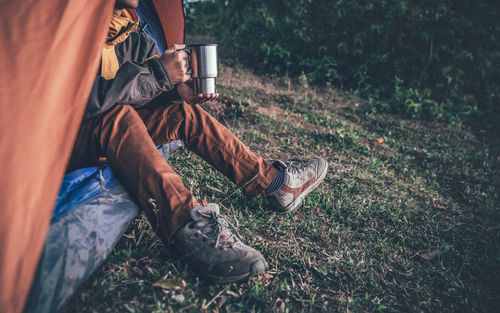 Low section of man sitting outdoors