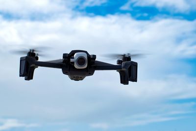 Low angle view of drone camera against blue sky