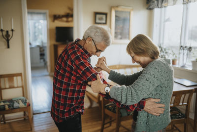 Senior couple dancing at home