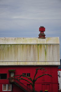 Low angle view of red building against sky