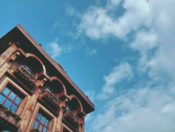 Low angle view of building against cloudy sky