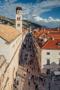 Panoramic view of people in city against sky