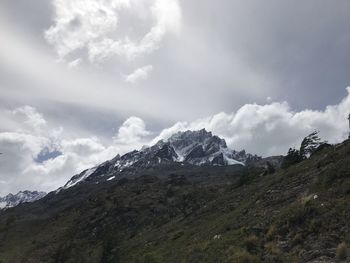 Scenic view of mountains against cloudy sky