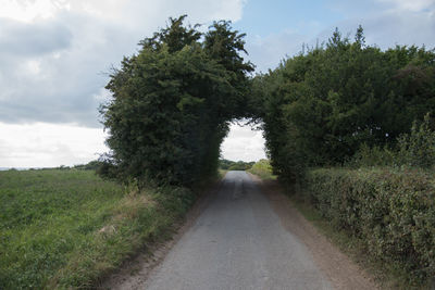 Empty narrow country road along landscape