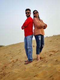 Full length of young couple on beach