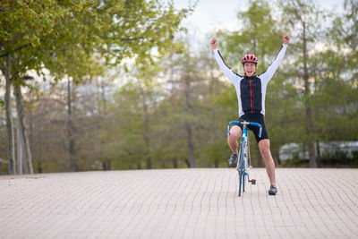 Full length of man riding bicycle