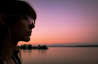 Portrait of silhouette man in sunglasses against sky during sunset