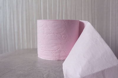 Close-up of paper on table against wall at home