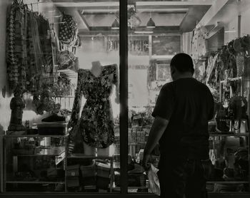 Rear view of man standing in store