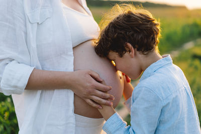 Midsection of couple holding hands