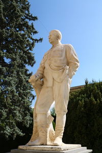 Low angle view of statue against clear blue sky