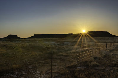 Scenic view of field against sky during sunset