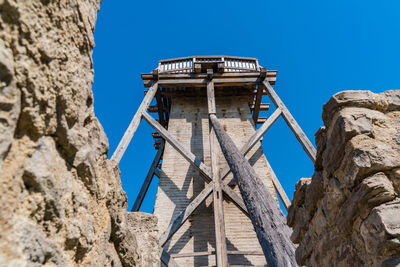 Low angle view of old building against clear blue sky