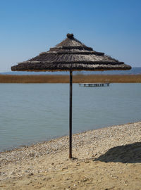 Built structure on beach against clear sky