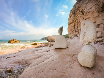 Rocks on beach against sky