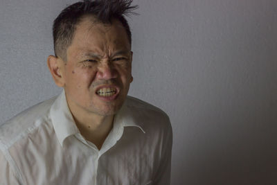 Portrait of man against wall