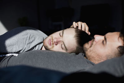 Portrait of young man sleeping on bed