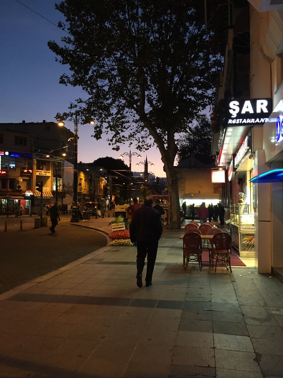 building exterior, architecture, built structure, illuminated, street, city, residential structure, residential building, night, building, house, transportation, street light, lighting equipment, outdoors, city life, incidental people, dusk, the way forward, clear sky