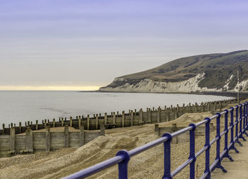 Scenic view of sea and mountains against sky