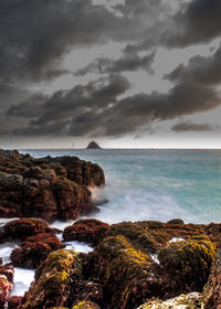 Scenic view of sea against cloudy sky