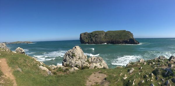 Scenic view of sea against clear blue sky