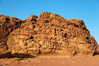 Graffiti on rock formation against clear sky