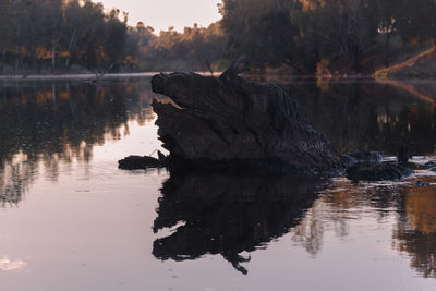 Scenic view of lake against sky at sunset