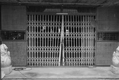 View of metal fence against wall