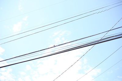 Low angle view of power lines against sky