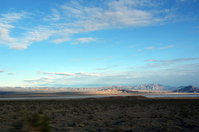 Scenic view of desert against blue sky