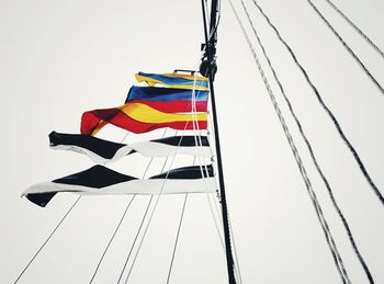 Low angle view of flags against clear sky