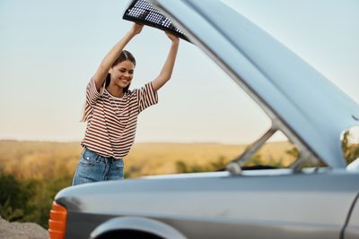 Side view of woman with arms raised