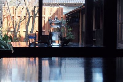 Reflection of potted plants on glass window