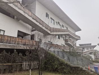 Low angle view of abandoned building against sky