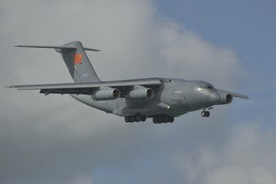 Low angle view of airplane flying against sky