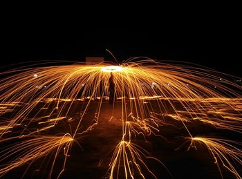 Low angle view of firework display at night