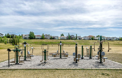 Playground in park against cloudy sky