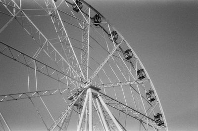 Low angle view of ferris wheel against sky