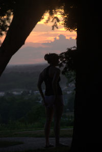 Silhouette of woman standing on mountain