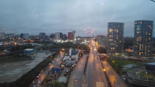 High angle view of illuminated cityscape against sky at night