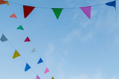 Low angle view of flags against sky