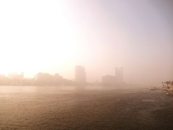 Scenic view of buildings in city against sky
