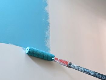 Close-up of ropes on table against blue wall