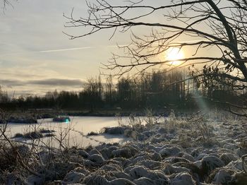 Scenic view of snow covered land during sunset